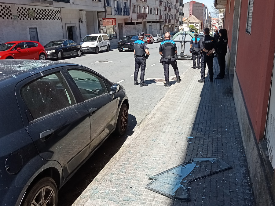 Arrojan a la calle desde el edificio okupa de Abesadas, en Ribeira, el cristal de una ventana que causa daños en un coche aparcado