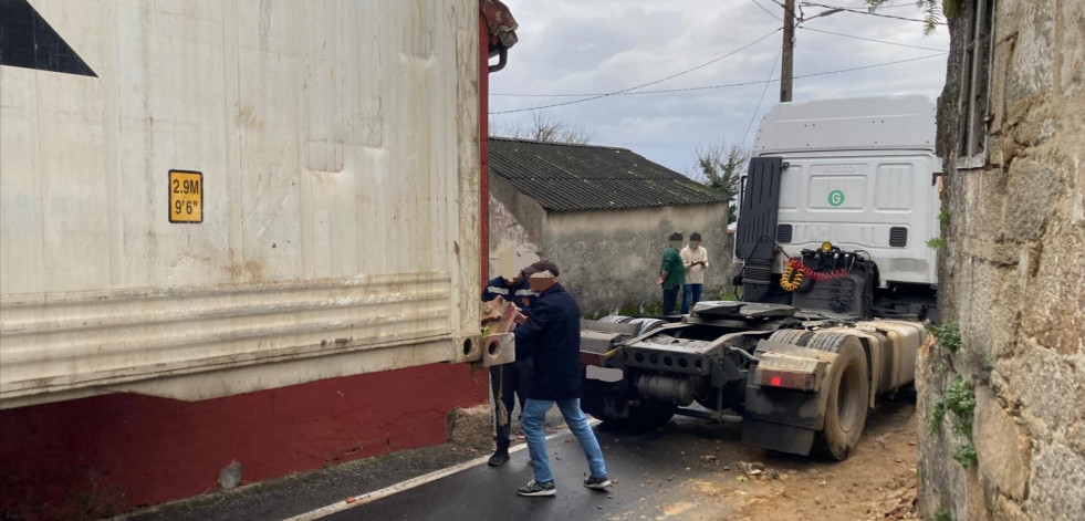 Un tráiler guiado erróneamente por el GPS queda atrapado en Deán Grande y derriba una casa